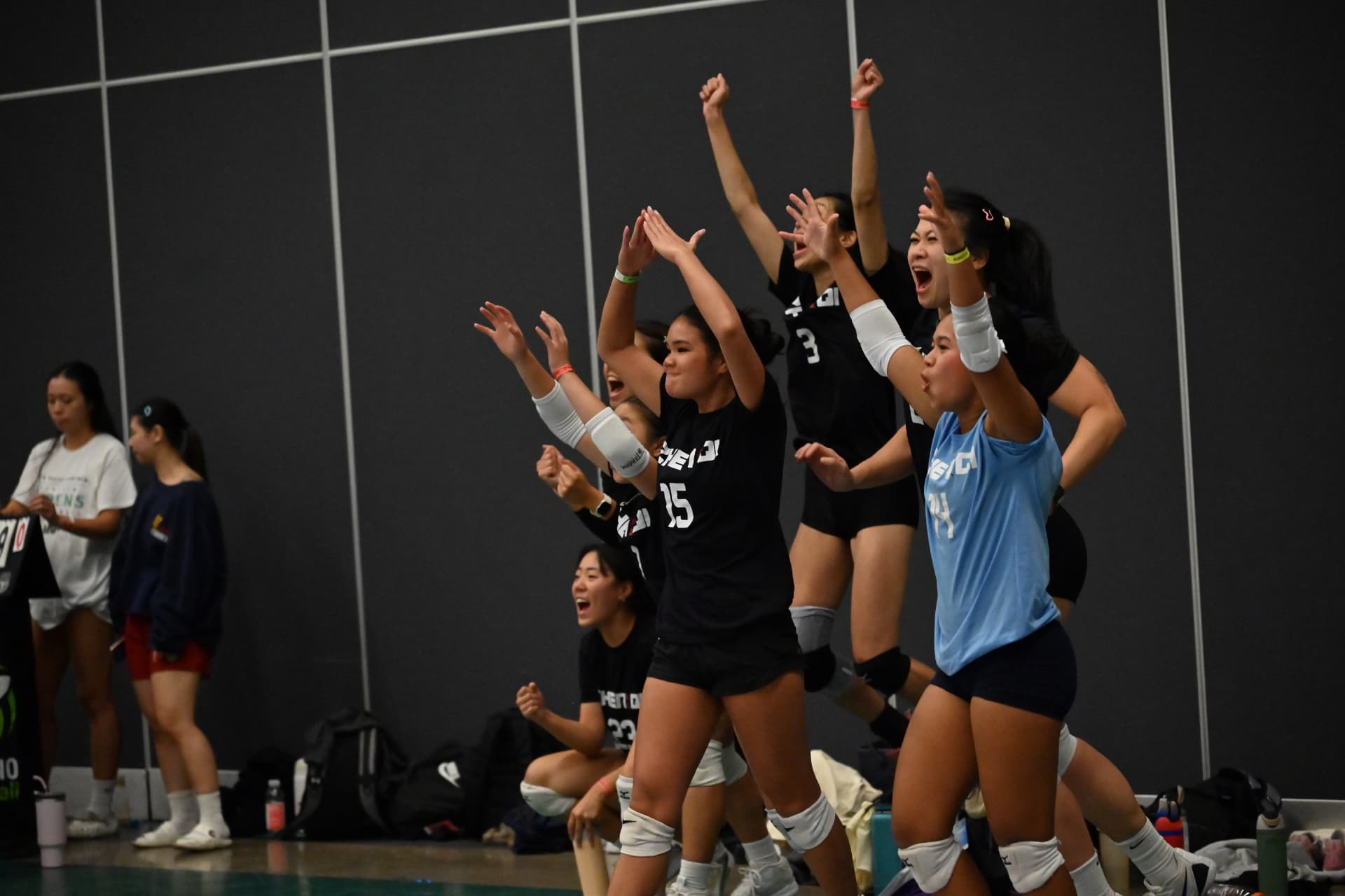 Asian volleyball players competing at the net
